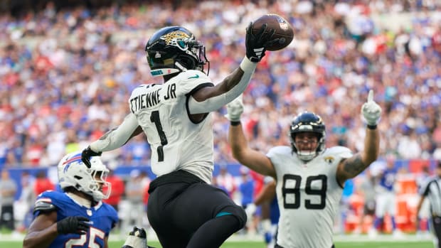 Oct 8, 2023; London, United Kingdom; Jacksonville Jaguars running back Travis Etienne Jr. (1) jumps into the end zone for a touchdown during the second half of an NFL International Series game against the Buffalo Bills at Tottenham Hotspur Stadium. Mandatory Credit: Peter van den Berg-USA TODAY Sports